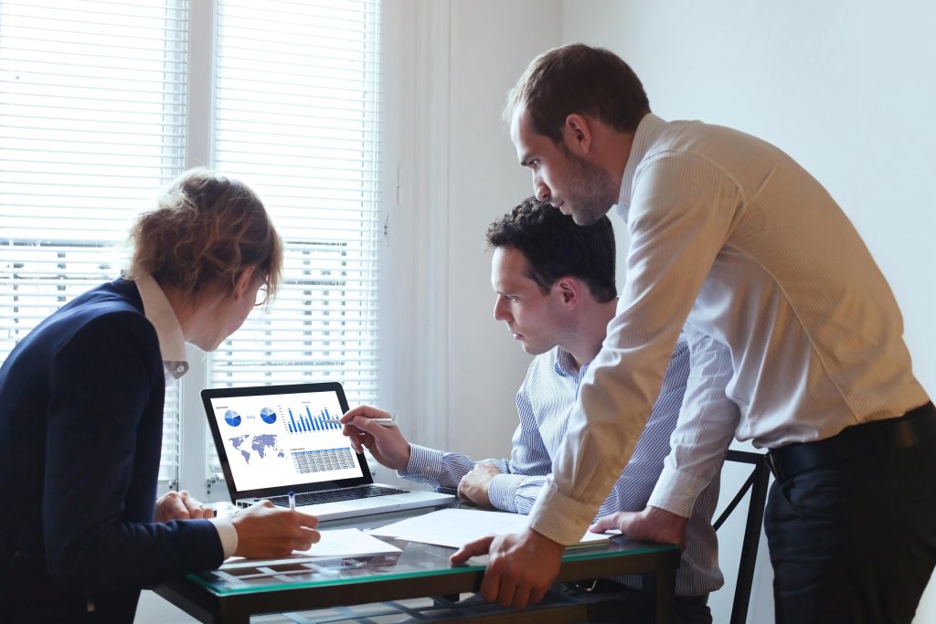 2-men-and-a-woman-looking-at-laptop